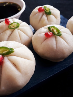 A picture of Steamed Rice ball stuffed with twisted pasta.