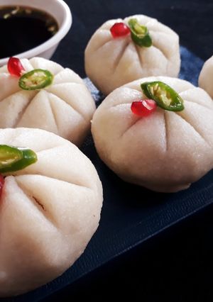 A picture of Steamed Rice ball stuffed with twisted pasta.