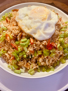 A picture of Nasi Goreng with sunny side up (Indonesian style fried rice with half fry egg).