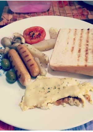 A picture of Cheese Spanish omelette grilled sausage mushroom,olives& toast.