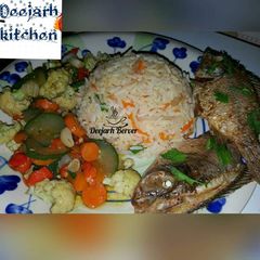 Carrot rice/veg sauces/fried fish A picture of Carrot rice/veg sauces/fried fish.