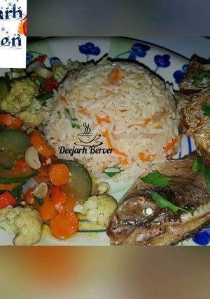 A picture of Carrot rice/veg sauces/fried fish.