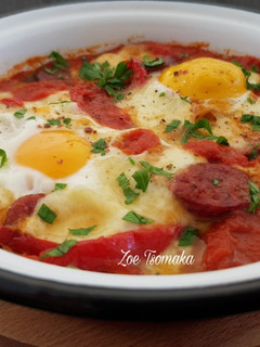 A picture of Saganaki with Country Sausage, Eggs, and Graviera Cheese.