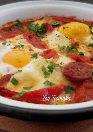 A picture of Saganaki with Country Sausage, Eggs, and Graviera Cheese.