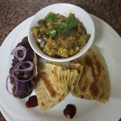 A picture of Eggplantscurry,goatsufuriaroast andchapati#weeklyjokochallenge&.