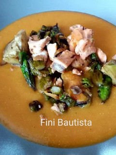 Una foto de Salteado de salmón sobre crema de calabaza