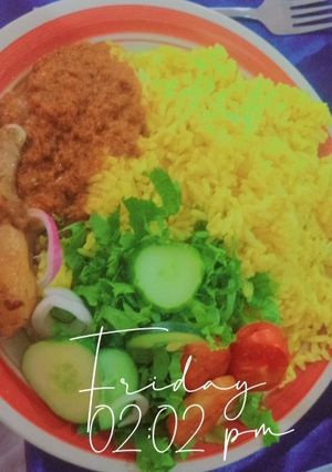 A picture of Curry rice with fried chicken in tomato sauce and slide salad.