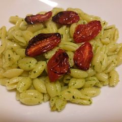 A picture of Pasta with mint and pistachio pesto and roasted tomatoes.