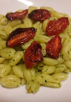 A picture of Pasta with mint and pistachio pesto and roasted tomatoes.