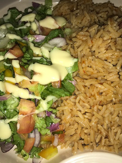 A picture of Jellof rice and salad.