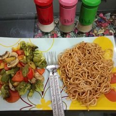 A picture of Sauteed vegetables with noodles.