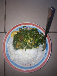 A picture of White rice and veggies sauce.