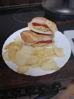 Una foto de Bocadillo de lomo adobado con pimiento del piquillo, tortilla y queso
