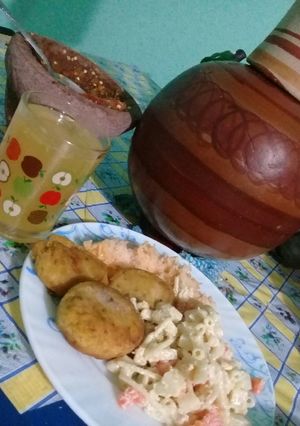 A picture of Plantain Patties, Rice, Cold Salad / Mandarin Water.