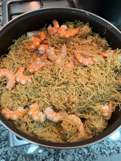 Una foto de Fideos fritos con langostinos y emulsión de pimientos piquillo