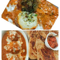 A picture of Malai kofta in red gravy.