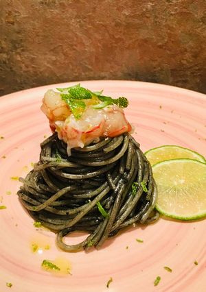 A picture of Squid Ink Spaghetti with Shrimp Tartare and Lime.