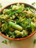 Fried rice topped with green veggies