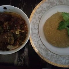 A picture of Goatmeat peppersoup with garri.