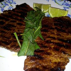 A picture of Pan Grilled Beef Steak with Sage leaves.