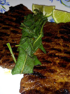 A picture of Pan Grilled Beef Steak with Sage leaves.