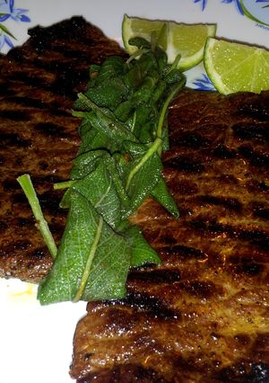 A picture of Pan Grilled Beef Steak with Sage leaves.