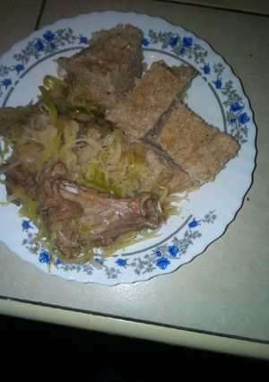 A picture of Brown ugali with mutton and cabbage.