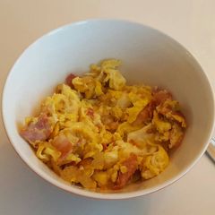 A picture of Bacon, eggs and chili.