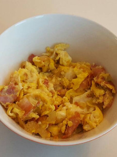 A picture of Bacon, eggs and chili.