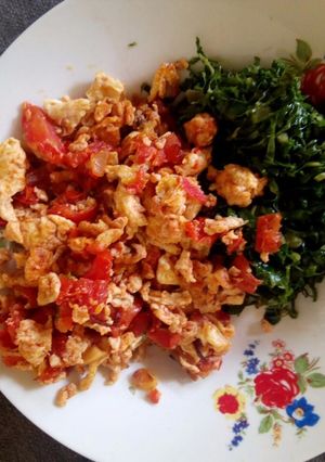 A picture of Scrambled eggs with greens.