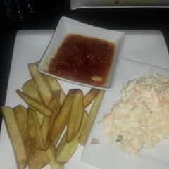 A picture of Fried yam with stew and coleslaw.