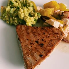 A picture of Tuna steak with cucumber guacamole.