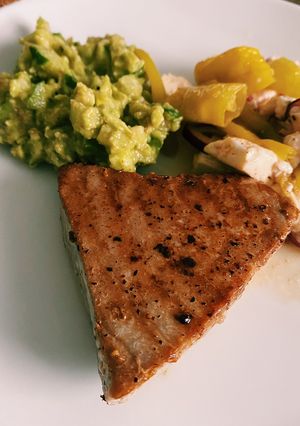 A picture of Tuna steak with cucumber guacamole.