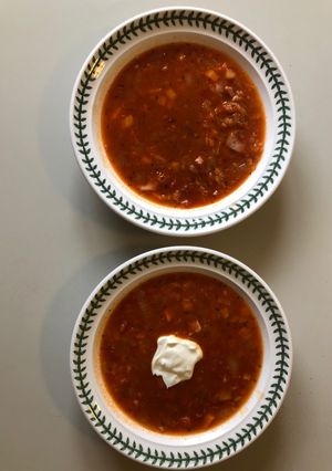 A picture of Tinned Tomato, Red Onion & Red Lentil soup (with ham stock & bits or vegetarian alternative).