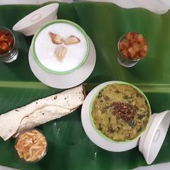 A picture of Palak panch dal khichdi tempered with burnt garlic.