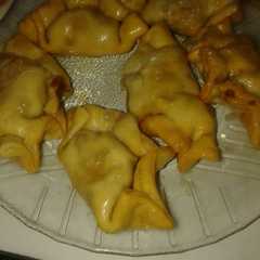 Una foto de Empanaditas de dulce de leche en almíbar