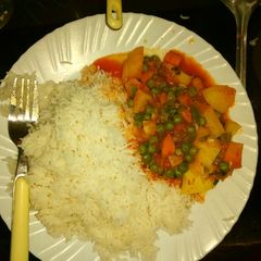 A picture of Potato curry with carrots and peas.