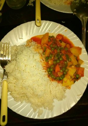 A picture of Potato curry with carrots and peas.