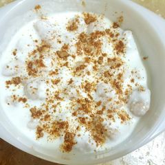 A picture of Dahi Bara /Yogurt with lentil dumplings.