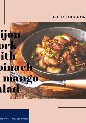 A picture of Dijon pork with spinach & mango salad.