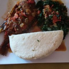 A picture of Wet fried fish, ugali and spinach.