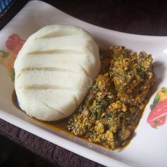 A picture of Pounded Yam and Egusi Soup with Bitterleaf.