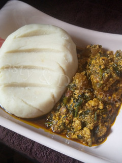 A picture of Pounded Yam and Egusi Soup with Bitterleaf.