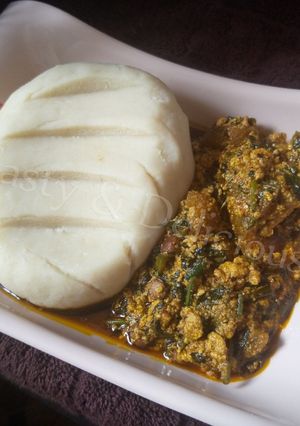 A picture of Pounded Yam and Egusi Soup with Bitterleaf.