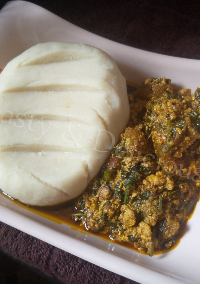 A picture of Pounded Yam and Egusi Soup with Bitterleaf.