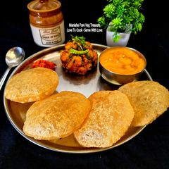 A picture of Aamras, Puri, Potato Dry Sabzi (Gujarati Mini Lunch Thali).