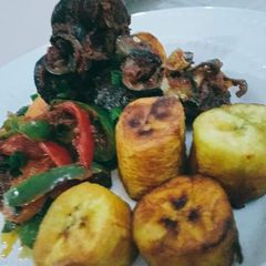 A picture of Fried plantain,and snails and vegetables.
