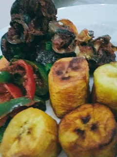 A picture of Fried plantain,and snails and vegetables.
