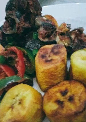 A picture of Fried plantain,and snails and vegetables.
