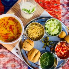 A picture of Mix grain baati and no onion garlic dal.